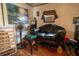 This living room features a black leather sofa, stool, and a window air conditioner at 7043 Curtis Ave, Groveland, FL 34736