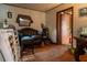 The living room has a black leather sofa, stool, and an open doorway to another room at 7043 Curtis Ave, Groveland, FL 34736