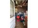 Room interior showing damaged ceiling and cluttered interior with various items at 7043 Curtis Ave, Groveland, FL 34736