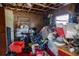 Interior room displaying cluttered storage, wooden walls, and an open view to the outside at 7043 Curtis Ave, Groveland, FL 34736