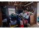 Room showing cluttered interior with wooden walls, window and various storage items at 7043 Curtis Ave, Groveland, FL 34736
