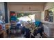 Overstuffed room with miscellaneous items piled around a window and furniture at 7043 Curtis Ave, Groveland, FL 34736