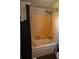 Bathroom features a shower and bathtub with old fixtures and a black shower curtain at 7043 Curtis Ave, Groveland, FL 34736