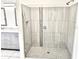 Modern tiled shower with glass enclosure and neutral-toned vanity at 11315 Cypress Shore Ct, Clermont, FL 34711