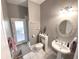 Traditional-style bathroom with pedestal sink, decorative mirror, and walk-in shower at 11315 Cypress Shore Ct, Clermont, FL 34711