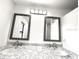 Bathroom featuring dual sinks, granite countertops, and framed mirrors at 11315 Cypress Shore Ct, Clermont, FL 34711