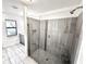 Modern bathroom with a sleek glass shower and contemporary tile at 11315 Cypress Shore Ct, Clermont, FL 34711