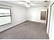 Spacious bedroom with neutral carpet and an ensuite bathroom, filled with natural light at 11315 Cypress Shore Ct, Clermont, FL 34711