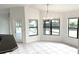 Bright dining area with tile floors and natural light from multiple windows at 11315 Cypress Shore Ct, Clermont, FL 34711