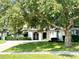 Charming single-story home featuring manicured landscaping and a lush lawn at 11315 Cypress Shore Ct, Clermont, FL 34711