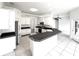 Large kitchen with an island, white cabinets, stainless appliances, and tile flooring at 11315 Cypress Shore Ct, Clermont, FL 34711
