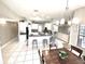 Open-concept kitchen with white cabinetry, a breakfast bar, and seamless flow to the living area at 11315 Cypress Shore Ct, Clermont, FL 34711