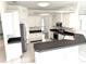 Bright kitchen featuring white cabinets, black appliances, and a functional breakfast bar for extra seating at 11315 Cypress Shore Ct, Clermont, FL 34711