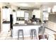 Modern kitchen with white cabinets, black countertops, and a breakfast bar for casual dining at 11315 Cypress Shore Ct, Clermont, FL 34711