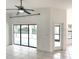 Light-filled living room with tile floors, sliding glass doors, and access to the outdoor area at 11315 Cypress Shore Ct, Clermont, FL 34711