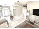 Inviting living room featuring tile flooring, neutral walls, and an open entryway for easy access at 11315 Cypress Shore Ct, Clermont, FL 34711