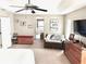 Large main bedroom with lounge area, decor, and neutral carpet at 11315 Cypress Shore Ct, Clermont, FL 34711