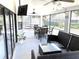 Screened patio with ceiling fans and wicker furniture, perfect for outdoor living at 11315 Cypress Shore Ct, Clermont, FL 34711