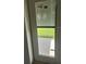 This back door provides access to the backyard with an exterior view of the green grass and patio at 13074 Sw 104Th Ln, Dunnellon, FL 34432