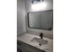 Elegant bathroom featuring a modern vanity with a quartz countertop and sleek black fixtures at 13074 Sw 104Th Ln, Dunnellon, FL 34432