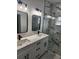 Stylish bathroom with double vanity, quartz countertops, and a glass-enclosed marble shower at 13074 Sw 104Th Ln, Dunnellon, FL 34432