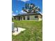 A spacious backyard and exterior view of the property with a new black roof at 13074 Sw 104Th Ln, Dunnellon, FL 34432