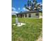 A spacious backyard and exterior view of the property with new black roof at 13074 Sw 104Th Ln, Dunnellon, FL 34432