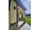 Inviting front porch with stone accents, modern lighting, and covered entry at 13074 Sw 104Th Ln, Dunnellon, FL 34432