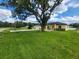 Charming single-story home with a well-manicured lawn and a spacious driveway at 13074 Sw 104Th Ln, Dunnellon, FL 34432