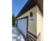 Clean garage with modern exterior lighting and clear address number, 13074 at 13074 Sw 104Th Ln, Dunnellon, FL 34432