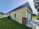 Exterior view of the home's side with garage, siding, and yard at 13074 Sw 104Th Ln, Dunnellon, FL 34432