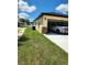 Attached two-car garage with a white pickup truck parked inside, and stone accents on the exterior at 13074 Sw 104Th Ln, Dunnellon, FL 34432