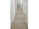 Long hallway with tile floors and white doors at 13074 Sw 104Th Ln, Dunnellon, FL 34432