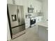 New kitchen features stainless steel appliances, gray island, and stone countertops at 13074 Sw 104Th Ln, Dunnellon, FL 34432