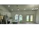 Modern kitchen with white cabinetry, stainless steel appliances, and an island with pendant lighting at 13074 Sw 104Th Ln, Dunnellon, FL 34432