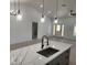 Stylish kitchen island featuring quartz countertops, a modern faucet, and an open view of the living space at 13074 Sw 104Th Ln, Dunnellon, FL 34432