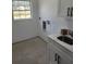 Functional laundry room with ample counter space, sink, and modern cabinets at 13074 Sw 104Th Ln, Dunnellon, FL 34432