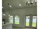 Bright living area with large windows and a door leading to the backyard, next to a modern kitchen at 13074 Sw 104Th Ln, Dunnellon, FL 34432