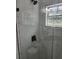 Shower with glass enclosure, and a view of the landscape at 13074 Sw 104Th Ln, Dunnellon, FL 34432