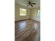 Sunny bedroom featuring laminate floors, neutral paint, and a ceiling fan at 2448 Austin Ave, Deltona, FL 32738
