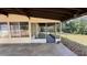 Screened porch perfect for enjoying the outdoors and an uncovered section for parking at 2448 Austin Ave, Deltona, FL 32738