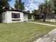 Charming one-story home featuring a well-manicured front yard with mature palm tree at 2448 Austin Ave, Deltona, FL 32738