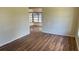 Spacious living room featuring neutral paint, laminate floors, and natural light at 2448 Austin Ave, Deltona, FL 32738