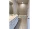 Modern bathroom featuring double vanity sinks, a tiled shower-tub combo, and tiled floors at 1710 Summer Rose Dr, Mount Dora, FL 32757