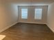 An empty bedroom with modern flooring, neutral paint, and two windows for natural light at 1710 Summer Rose Dr, Mount Dora, FL 32757