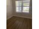 The bedroom features a window that brings in natural light, complemented by modern wood-look flooring at 1710 Summer Rose Dr, Mount Dora, FL 32757