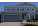 Charming two-story home boasts a well-maintained lawn and a convenient two-car garage at 1710 Summer Rose Dr, Mount Dora, FL 32757