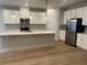 Spacious kitchen featuring white cabinets, quartz countertops, and stainless steel appliances at 1710 Summer Rose Dr, Mount Dora, FL 32757