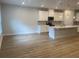 Open concept living area adjacent to kitchen features modern flooring and recessed lighting at 1710 Summer Rose Dr, Mount Dora, FL 32757