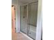 Modern bathroom shower with glass door, bench, and tiled walls at 1710 Summer Rose Dr, Mount Dora, FL 32757